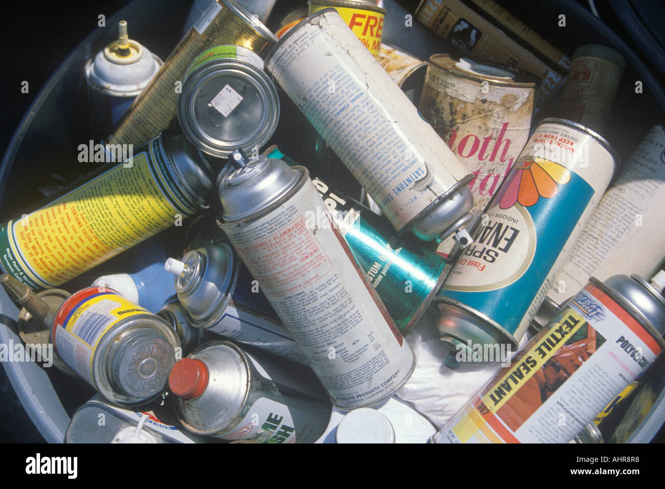 A bucket full of empty aerosol cans waiting for proper disposal Stock