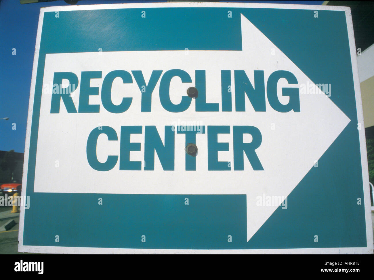 A large blue and white sign indicates a right turn for the recycling center Stock Photo