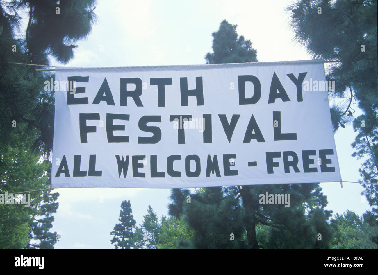 A hanging sign welcoming people to the Earth Day Festival Stock Photo