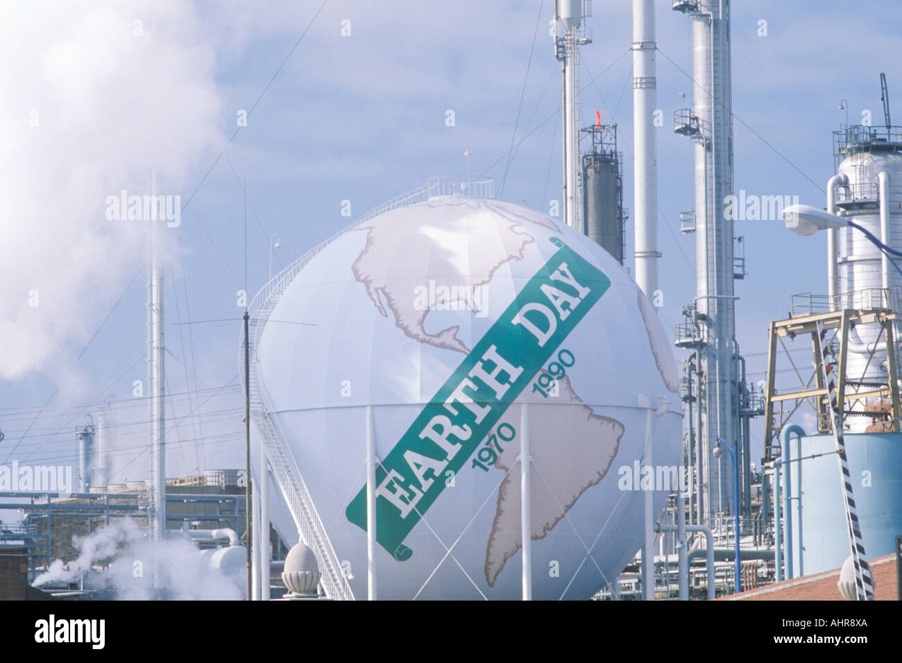 Tank painted as a globe with the words Earth Day 1970 1990 at a Unocal oil refinery in Los Angeles CA Stock Photo