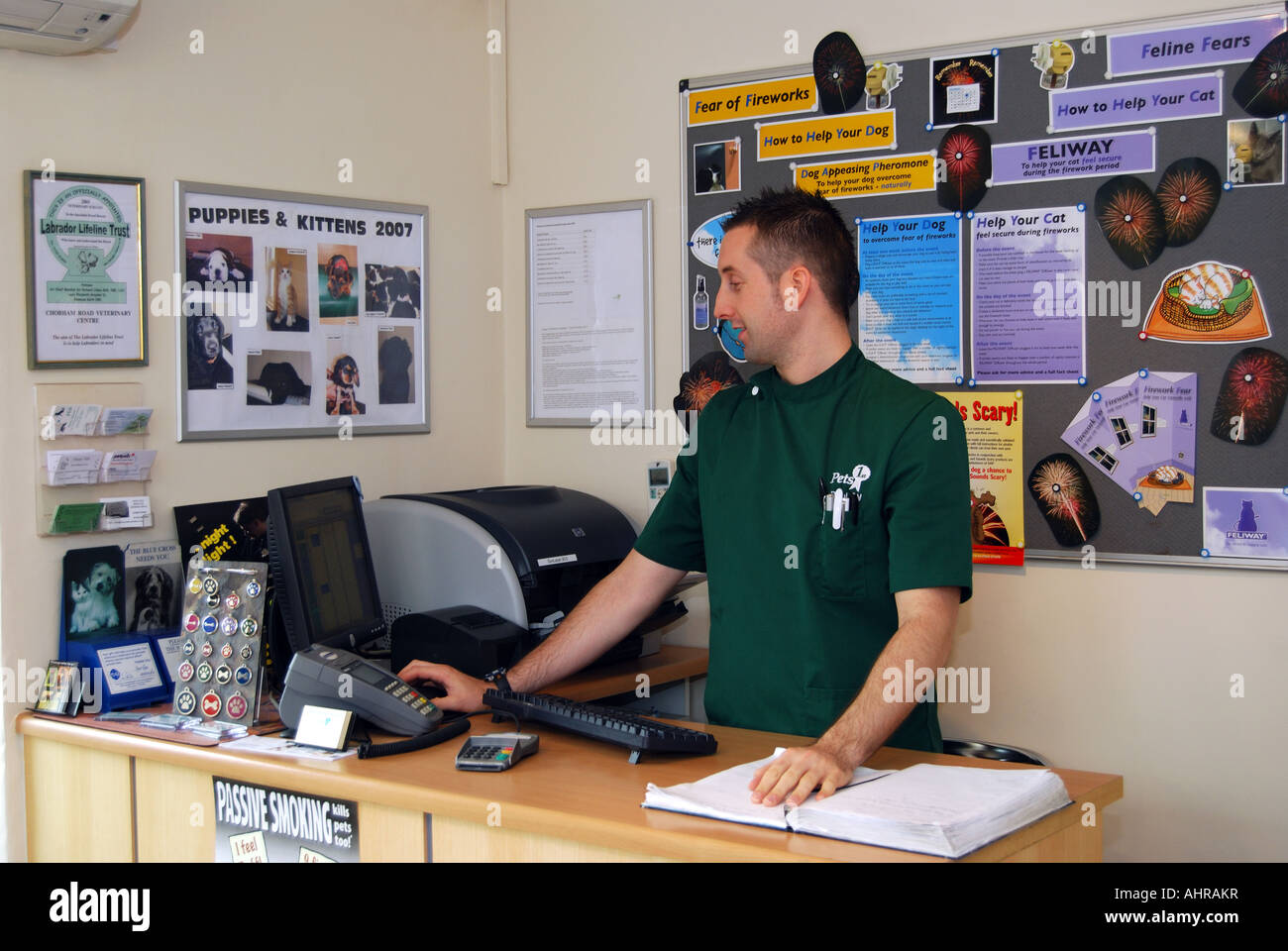Vet looking at computer in reception at Veterinary Clinic, Sunninghill
