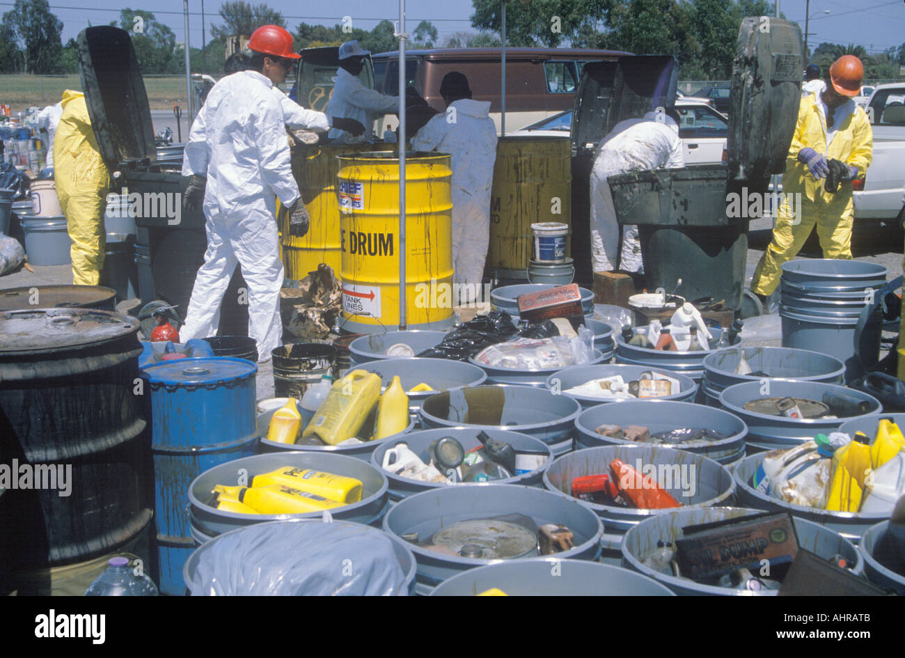 Workers handling toxic household wastes at waste cleanup site on Earth Day at the Unocal plant in Wilmington Los Angeles CA Stock Photo