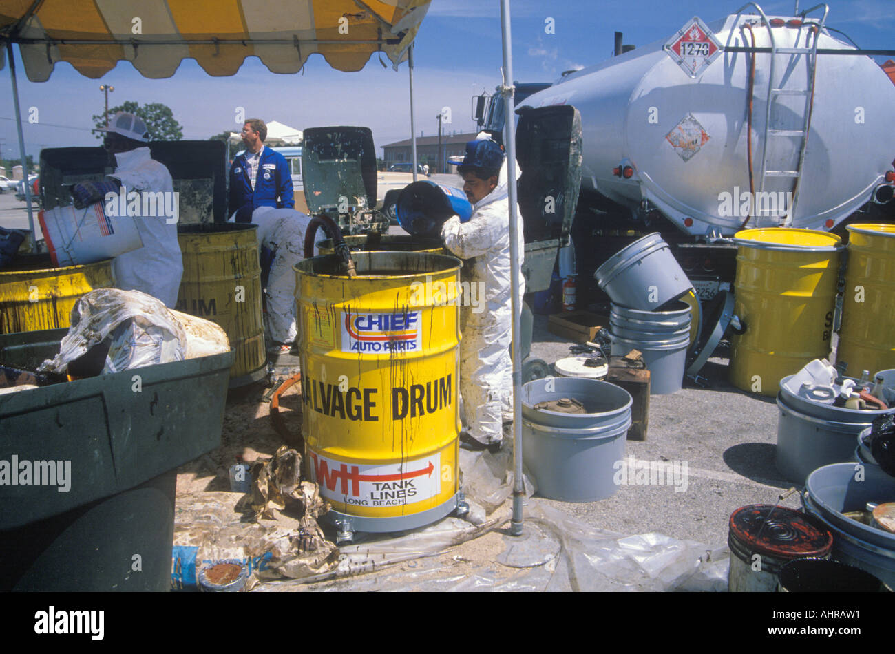 Workers handling toxic household wastes at waste cleanup site on Earth Day at the Unocal plant in Wilmington Los Angeles CA Stock Photo