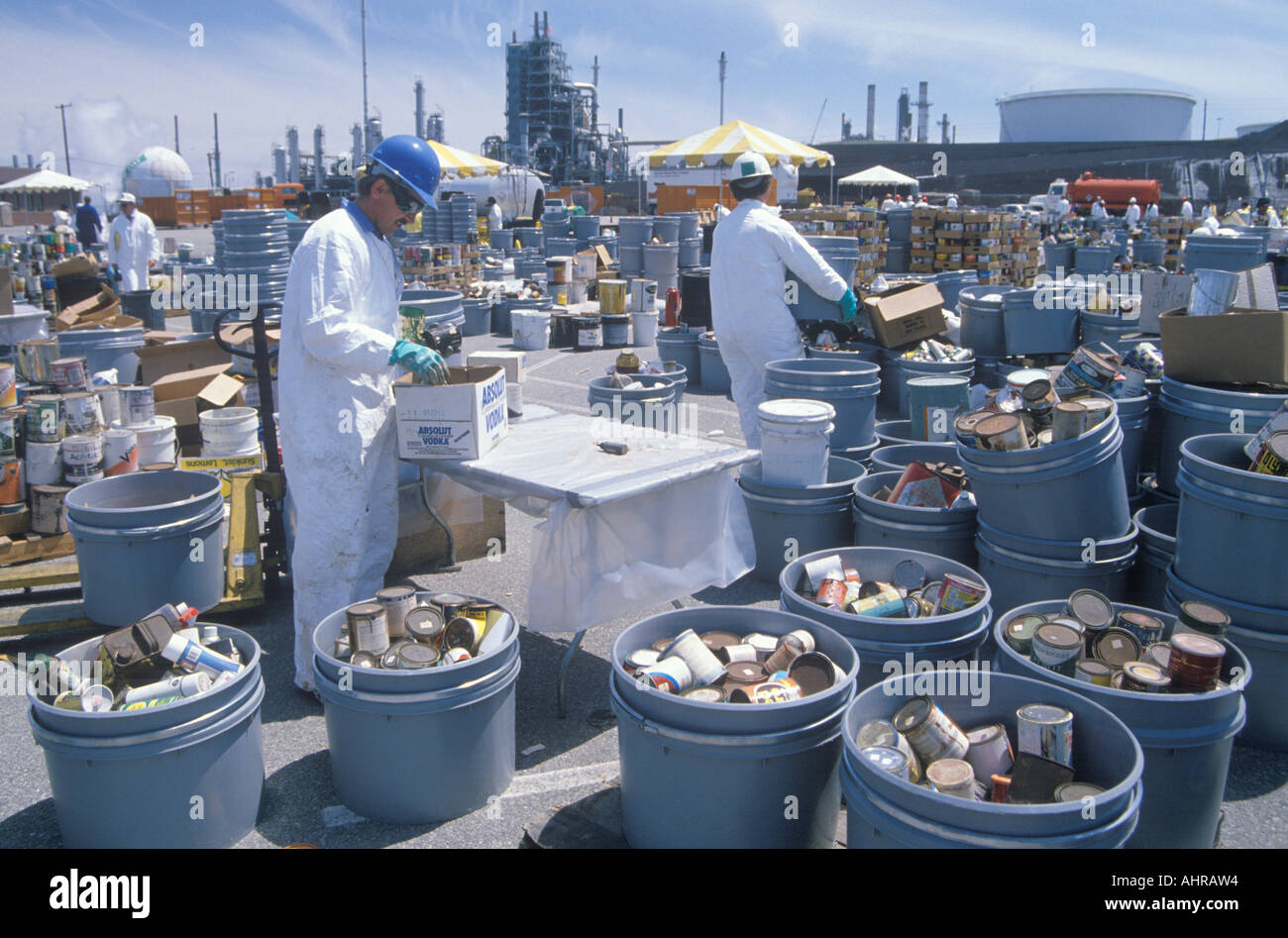 Workers handling toxic household wastes at waste cleanup site on Earth Day at the Unocal plant in Wilmington Los Angeles CA Stock Photo