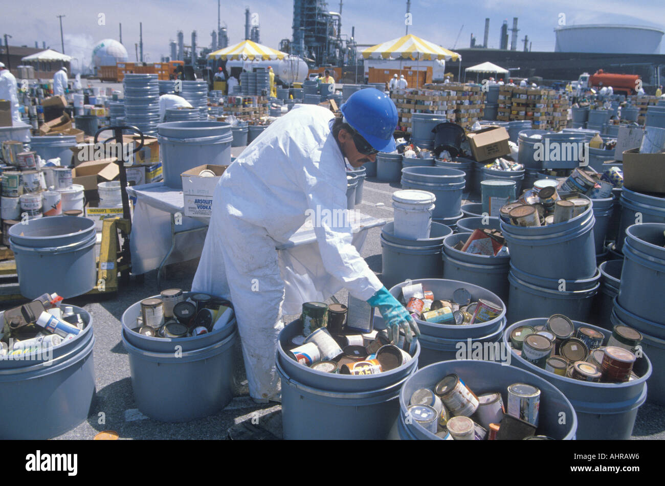 Worker sorting toxic wastes at waste cleanup site on Earth Day at the Unocal plant in Wilmington Los Angeles CA Stock Photo
