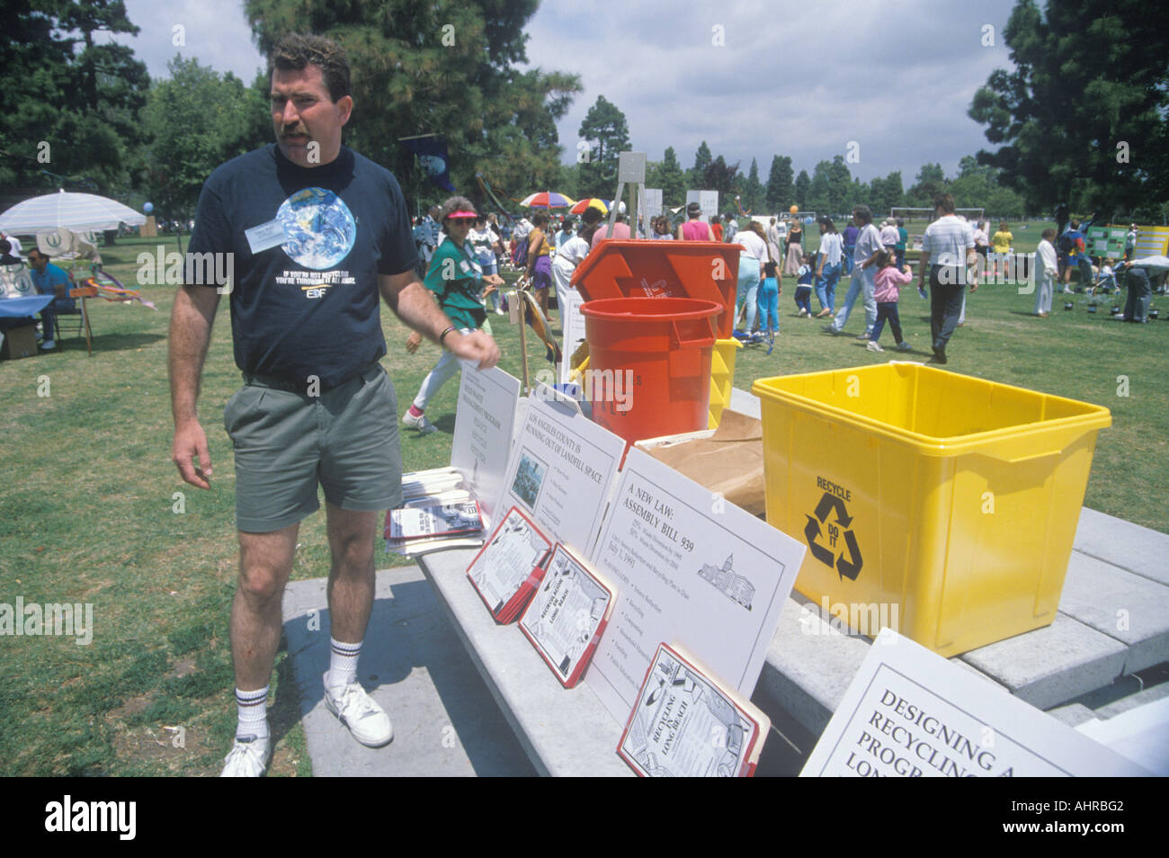 A coordinator standing by the registration desk ready to hand out instructions on Earth Day Stock Photo