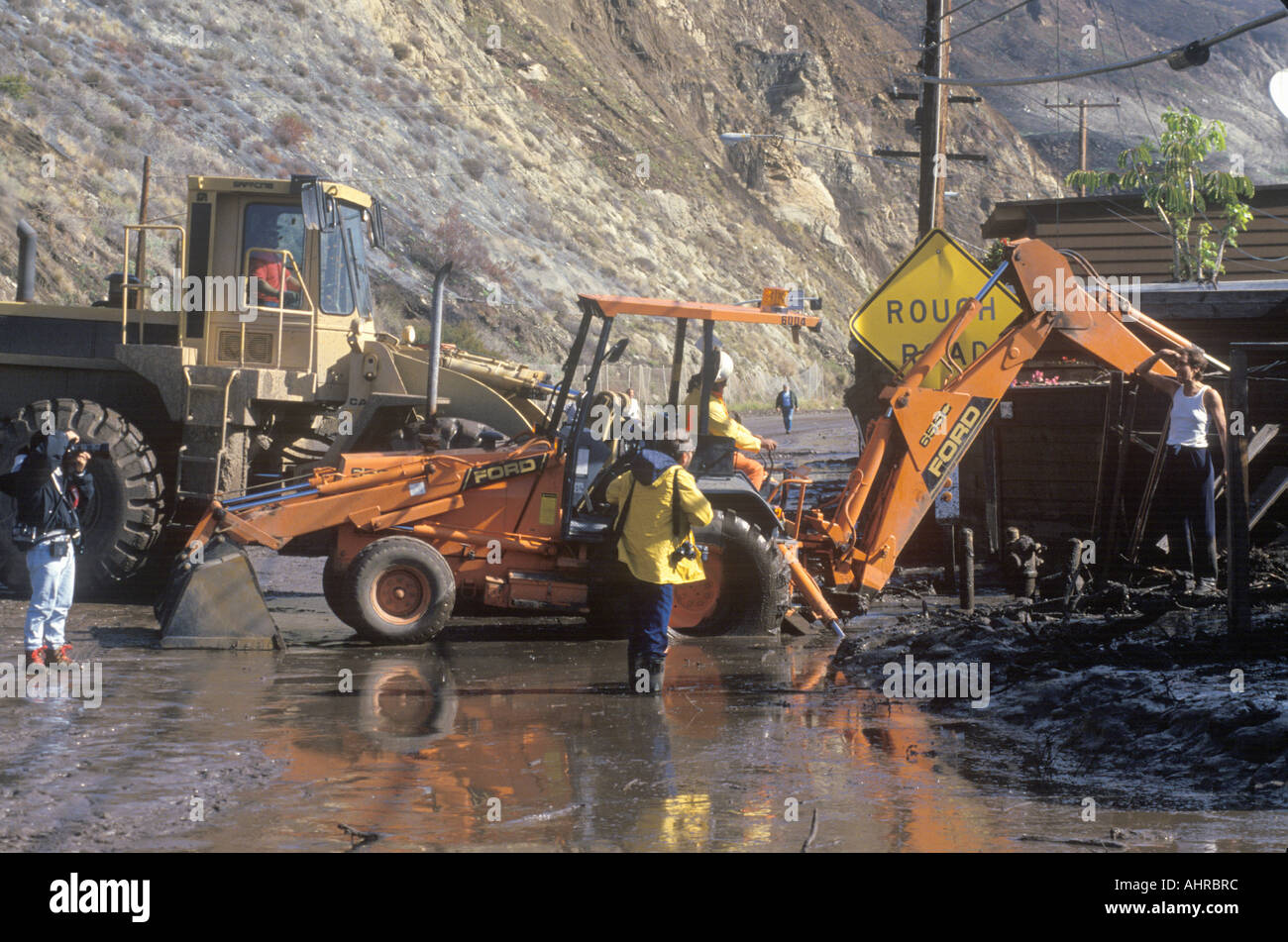 A wheel loader clearing the road after a major mudslide on the Pacific Coast Highway near Malibu CA Stock Photo