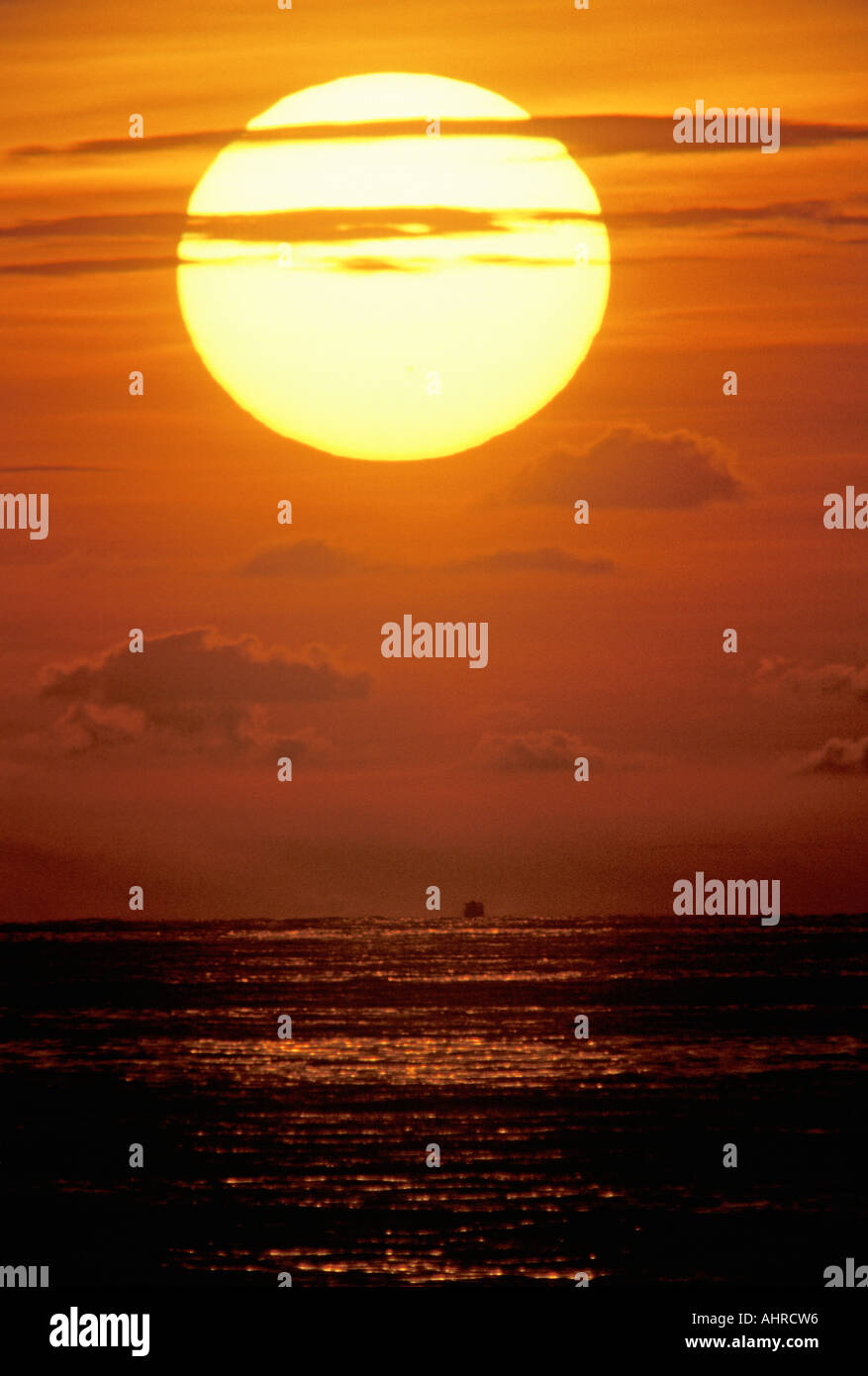 Sun Setting Over The Ocean Stock Photo