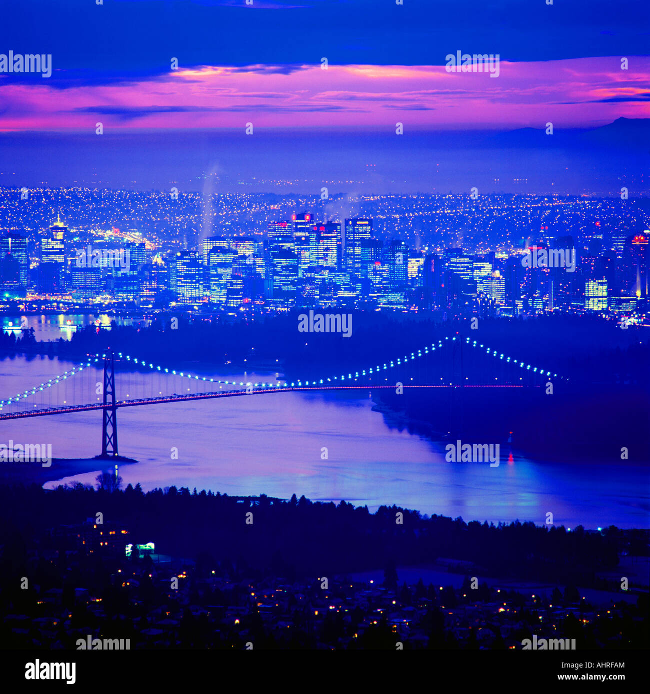 The Lions Gate Bridge and Stanley Park and the City of Vancouver British Columbia Canada at Night Stock Photo