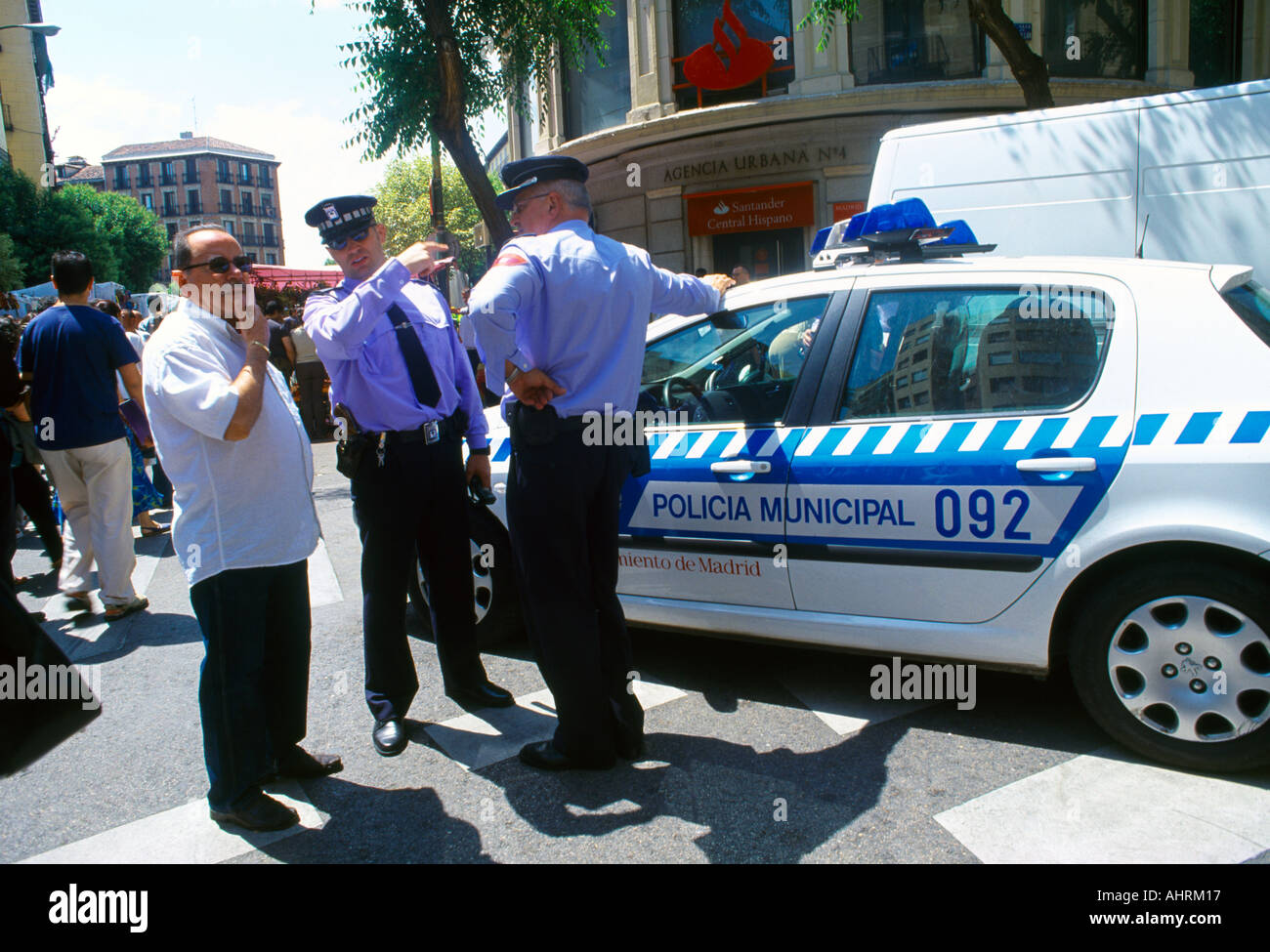Madrid Spain Policeman Giving Directions to Man Standing Next to Police Car Stock Photo