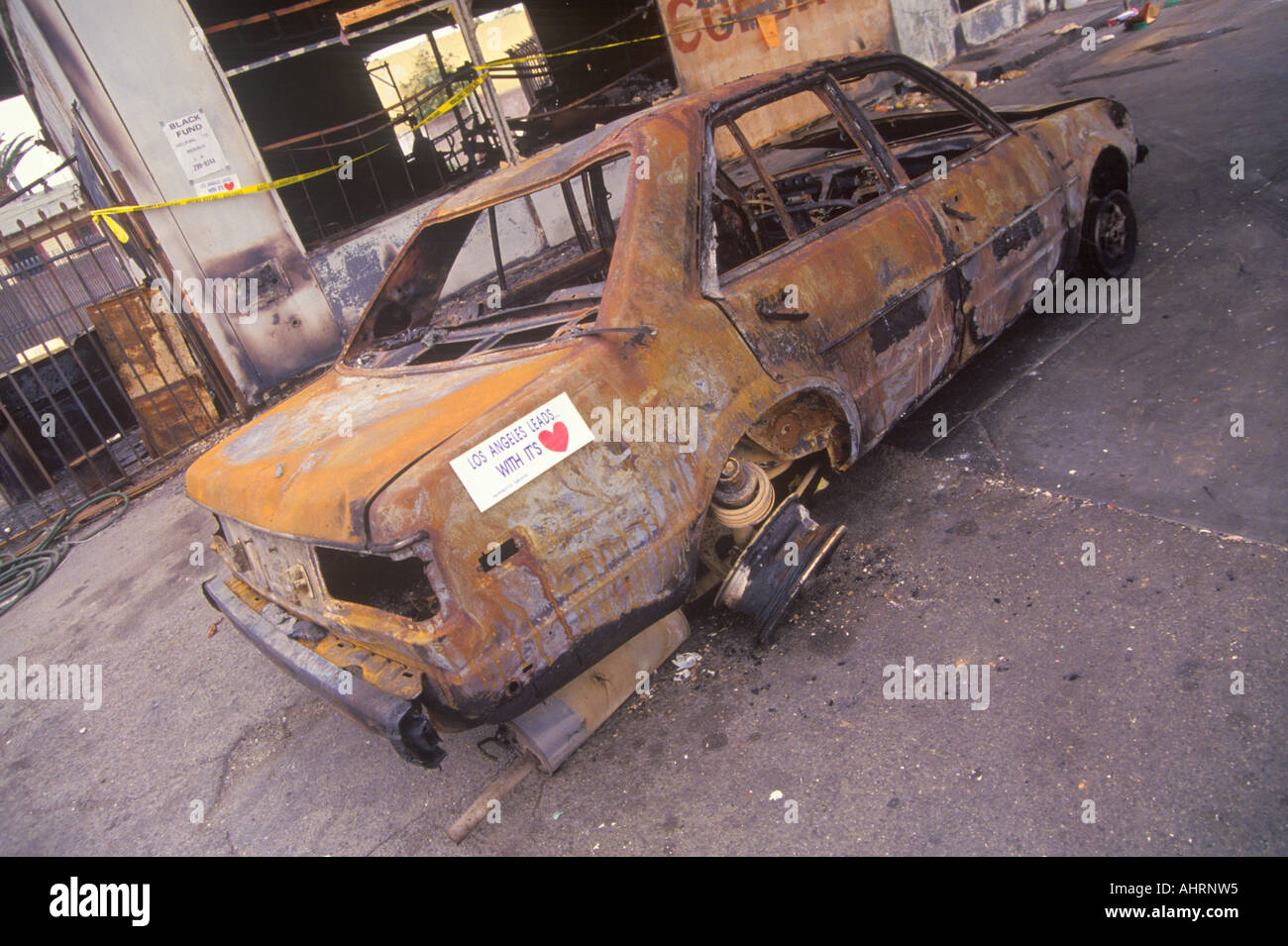 Car burned during 1992 riots South Central Los Angeles California Stock Photo