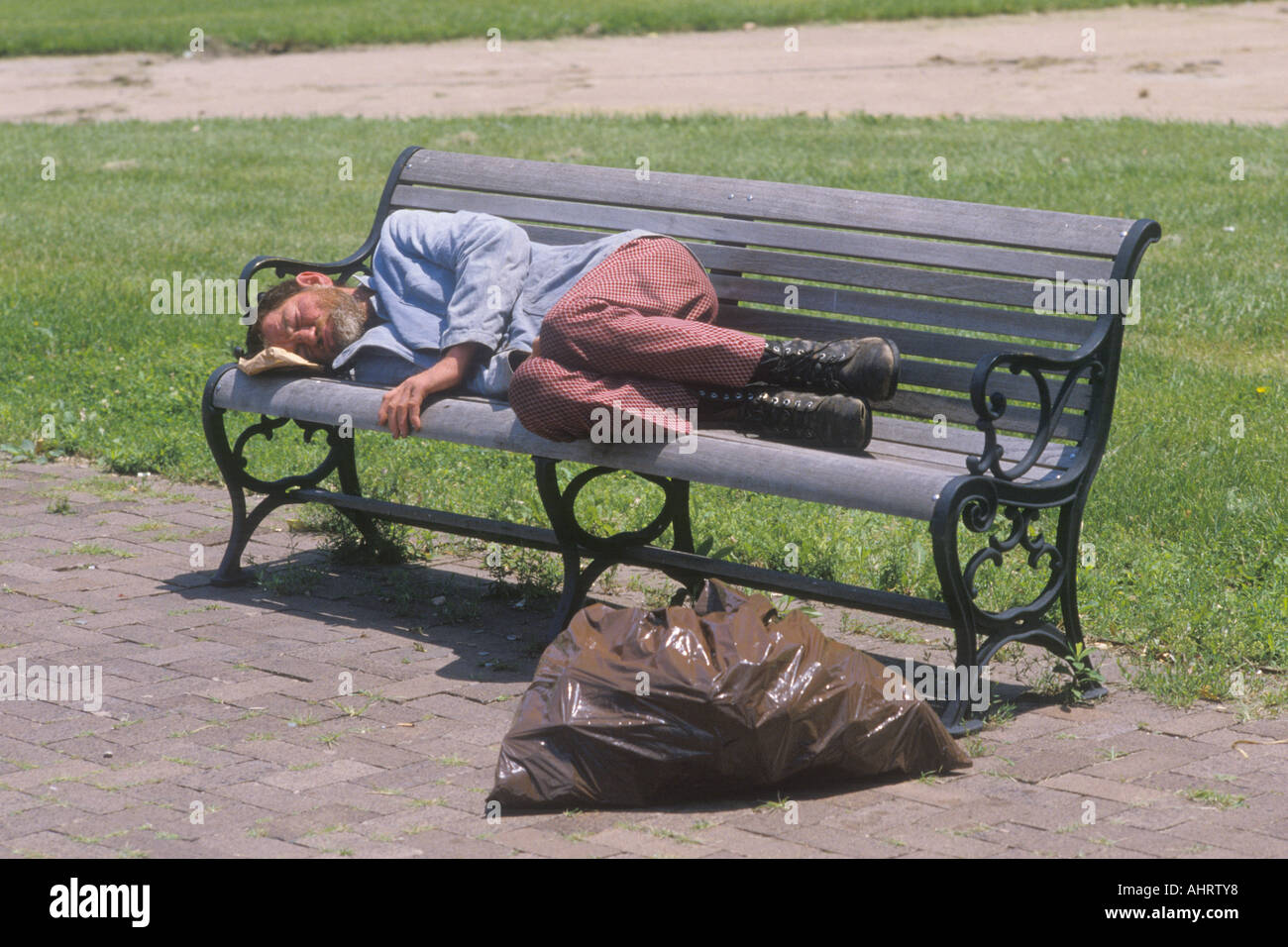Homeless man sleeping on a park bench Los Angeles California Stock Photo Alamy