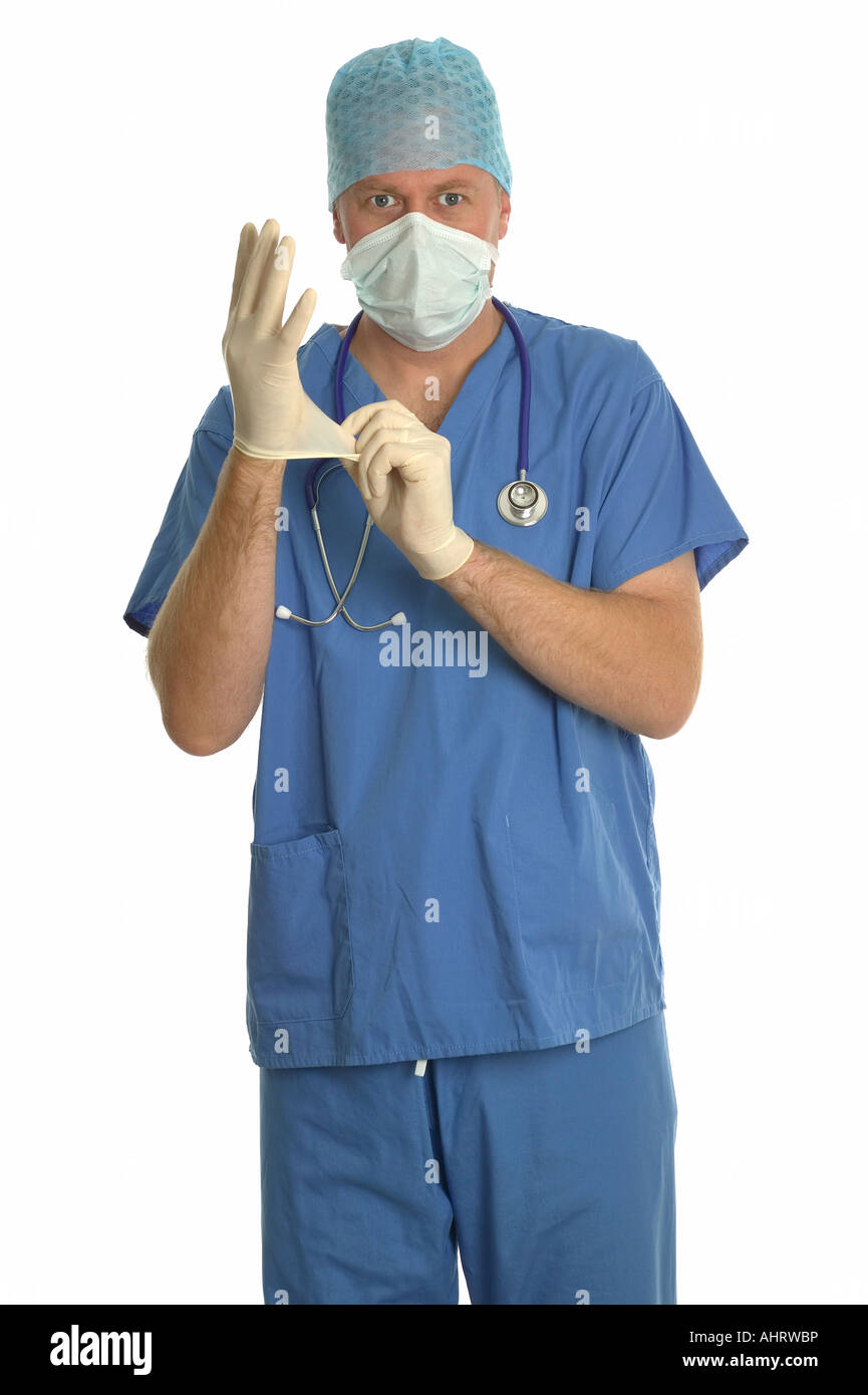 Surgeon in scrubs putting some latex gloves on Stock Photo Alamy
