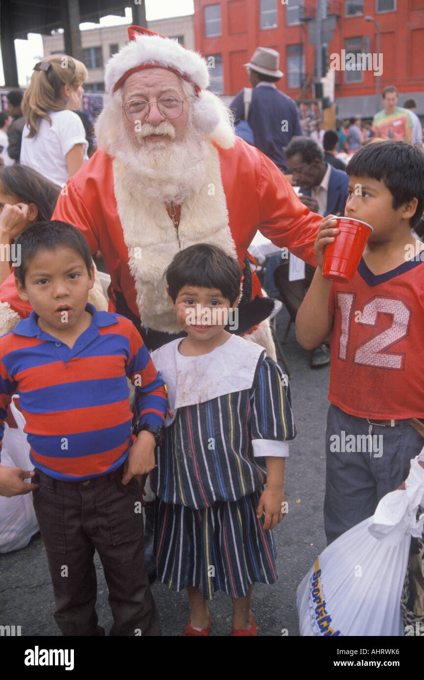 Santa Claus posing with homeless children at Christmas dinner Los