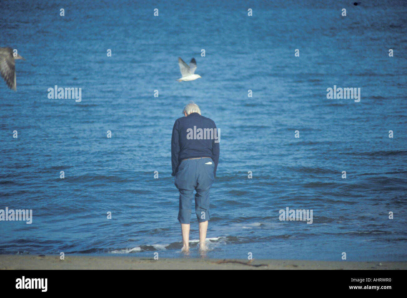 Barefoot man walking at beach San Francisco California Stock Photo
