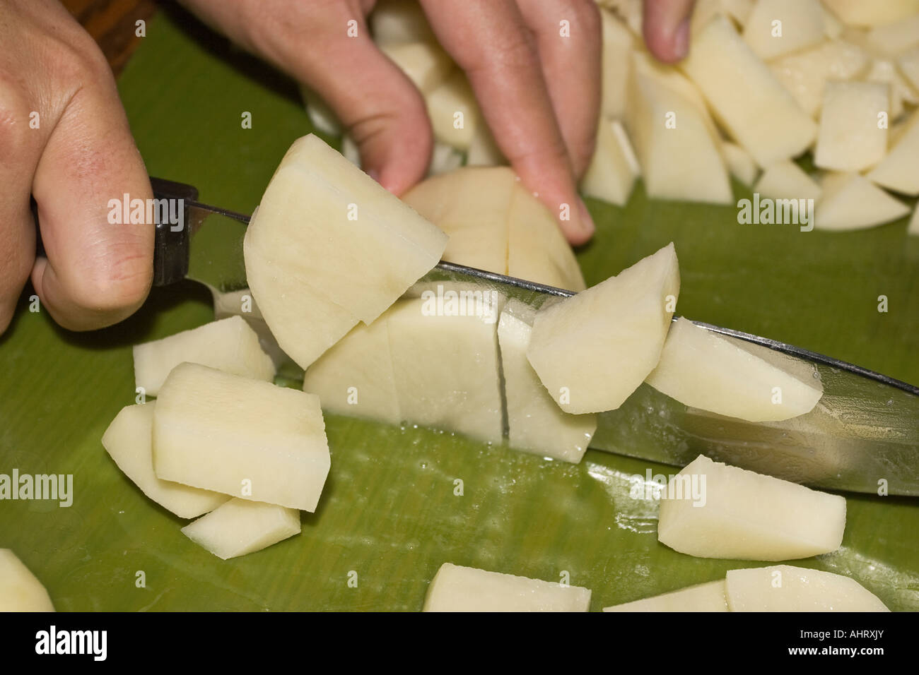 Woman chopping freshly washed potatoes with a knife Stock Photo Alamy