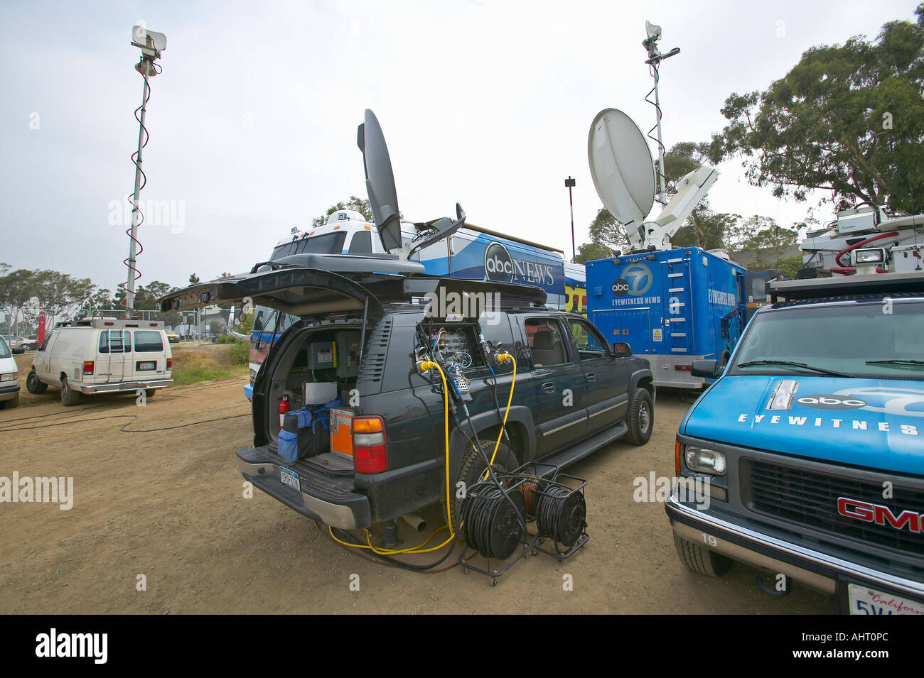 Media vans set up in dirt parking lot CSU Dominguez Hills Los Angeles CA Stock Photo