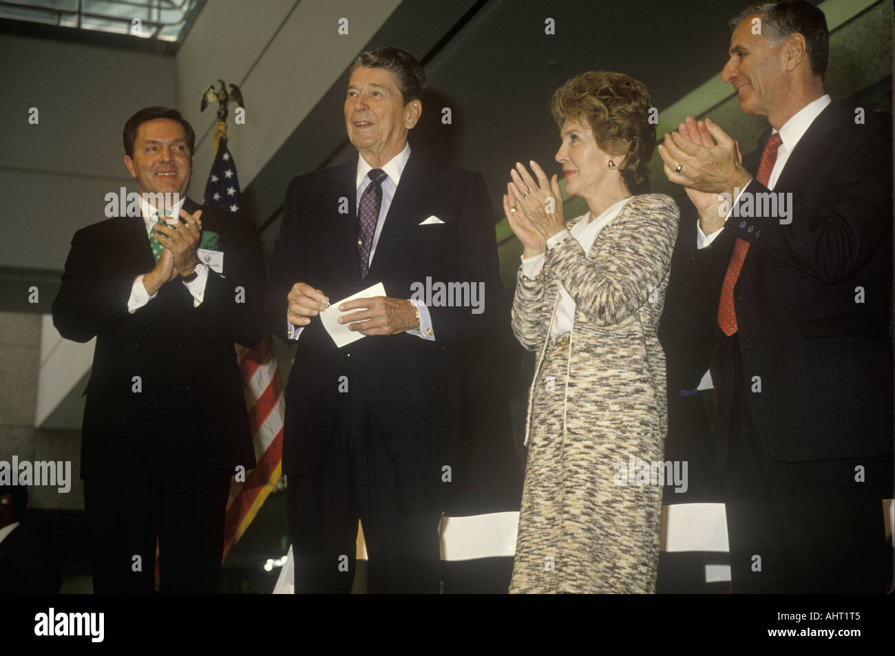 President Ronald Reagan Mrs Reagan and California governor George Deukmejian applaud Ronald Reagan Stock Photo