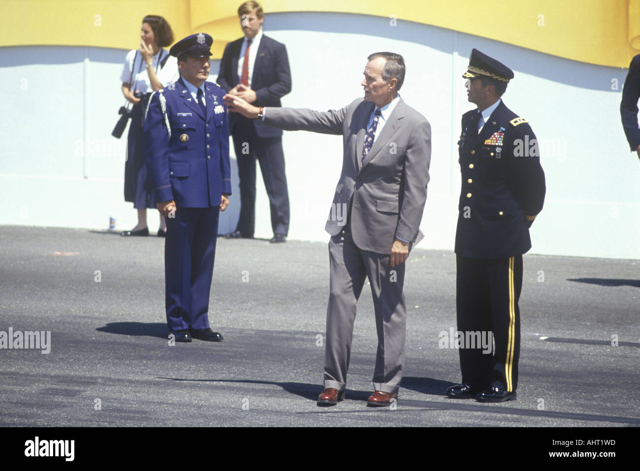 President Bush stands near the Presidential viewing booth with military officers during the Desert Storm Victory Parade in Stock Photo