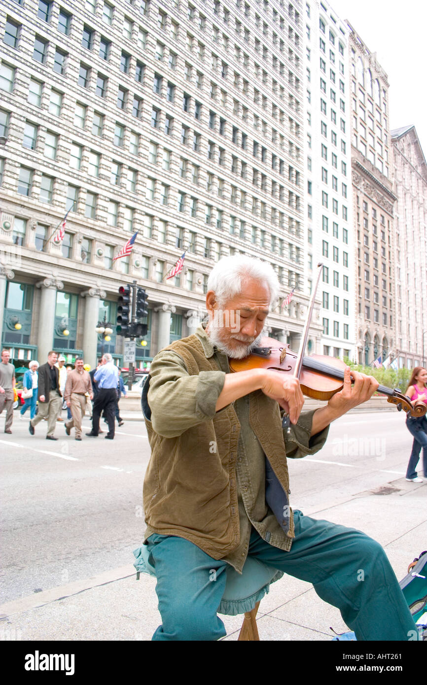 Street musician playing the violin on Michigan Avenue in front of the