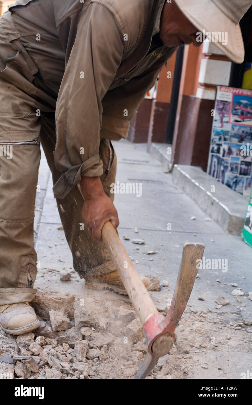 Worker digging up the pavement in La Paz Stock Photo