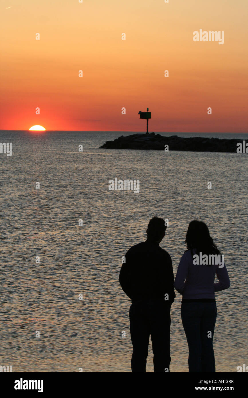 Couple watching sunset in New Buffalo, Michigan Stock Photo