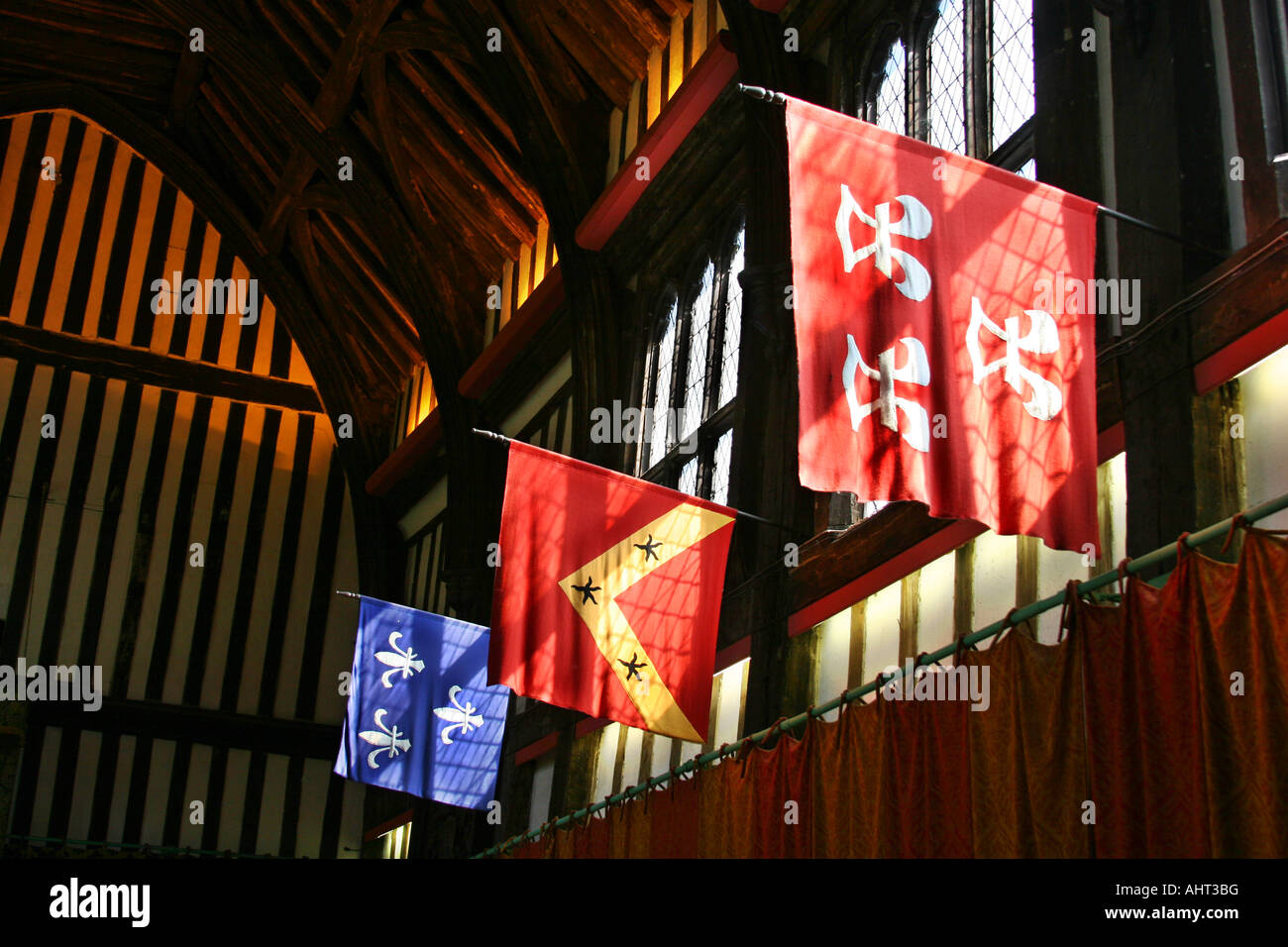Flags and sunlit windows inside Gainsborough Old Hall. Stock Photo