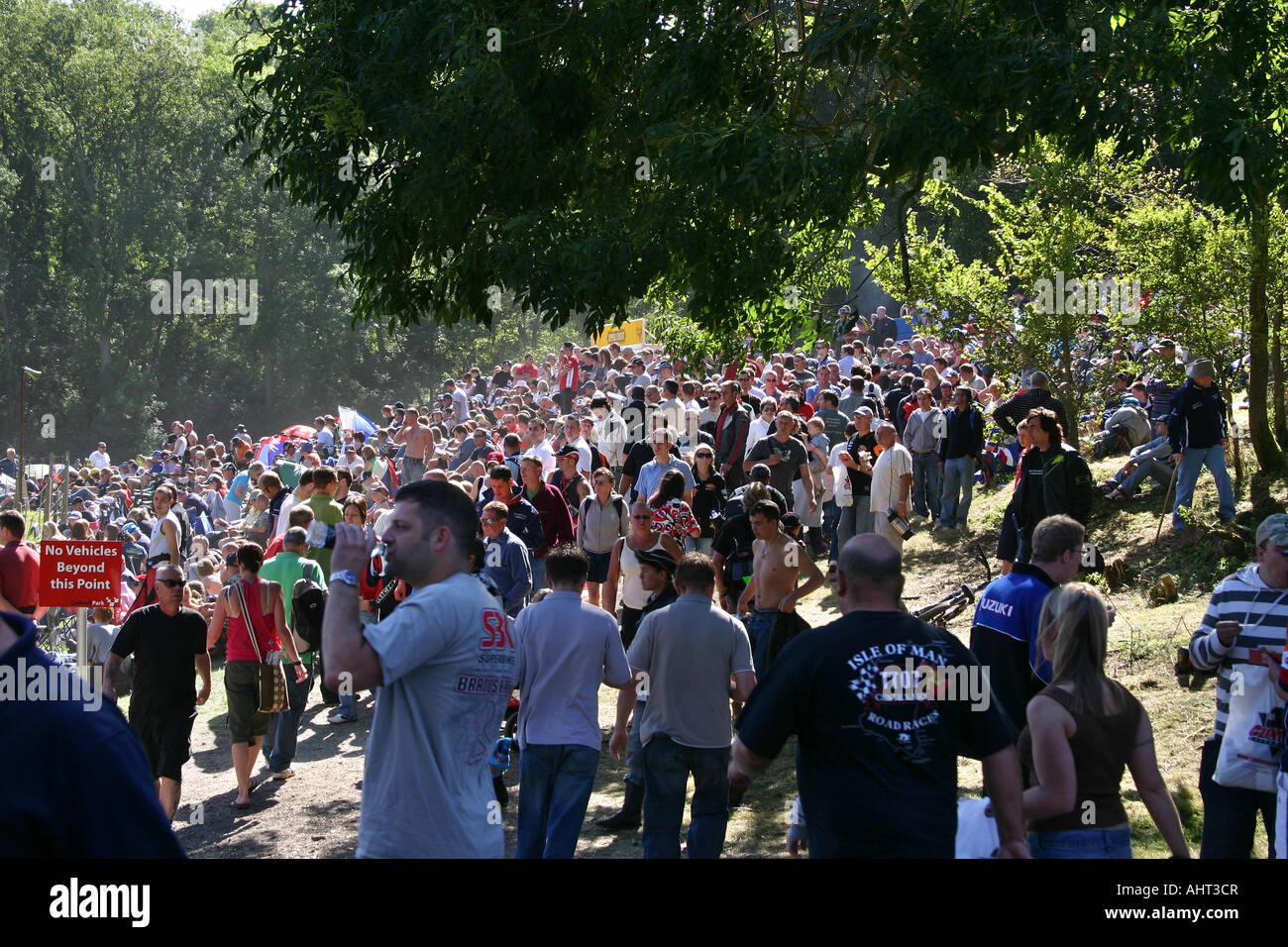 Large crowd of people close together watching motor cycle racing. Stock Photo