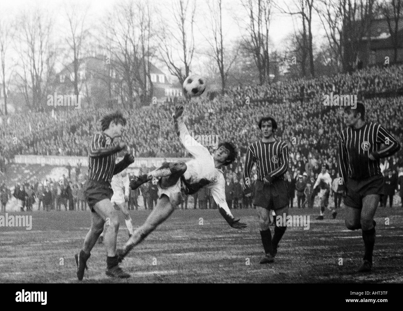 football, Regionalliga West, 1970/1971, Stadium am Zoo in Wuppertal, Wuppertaler SV versus Fortuna Duesseldorf 1:1, scene of the match, f.l.t.r. Robert Begerau (Ddorf), Guenter Proepper (WSV) with a sideways scissor-kick, Egon Koehnen (Ddorf), Werner Lung Stock Photo