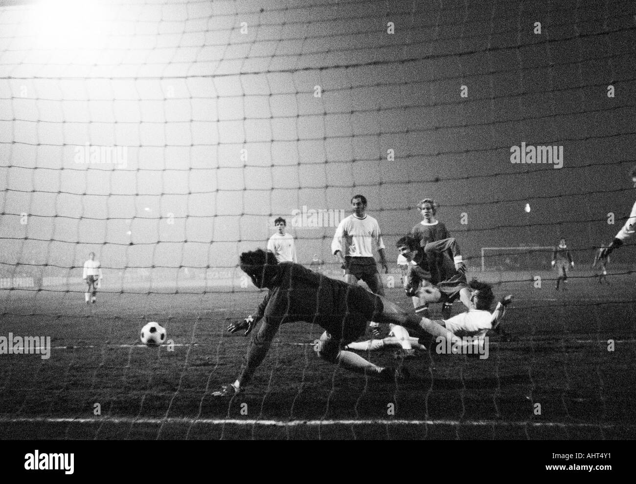 football, DFB Cup, quarter final, 1970/1971, Stadium Glueckaufkampfbahn in Gelsenkirchen, Schalke 04 versus Rot-Weiss Oberhausen 1:0, scene of the match, f.l.t.r. keeper Wolfgang Scheid (RWO), Hermann Josef Wilbertz (RWO), Klaus Fischer (S04), Juergen Sob Stock Photo