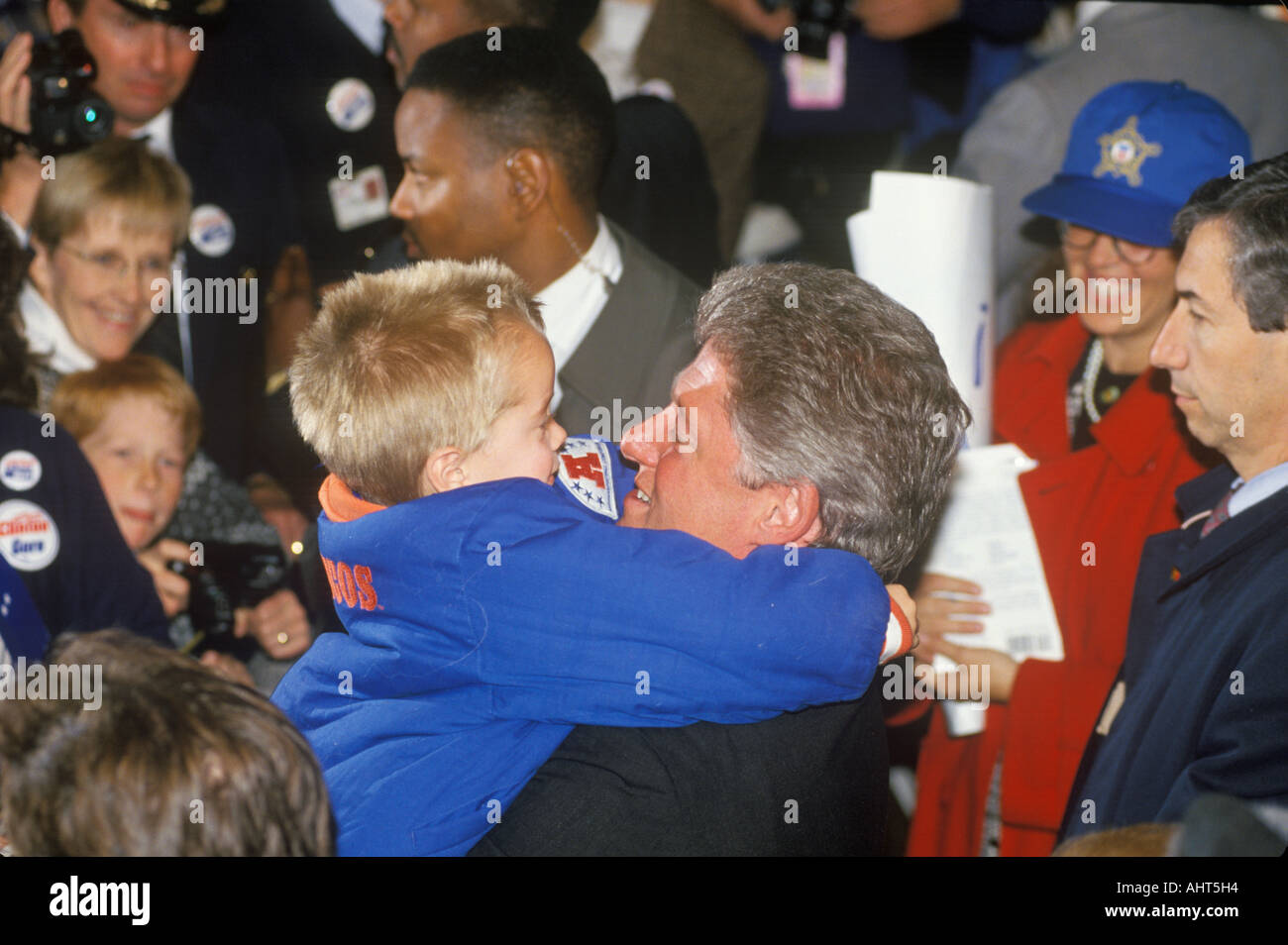 Governor Bill Clinton embraces a child at a Denver campaign rally in ...