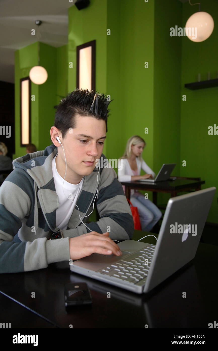 Young people surfing the internet through WLAN at an internet cafe Stock Photo