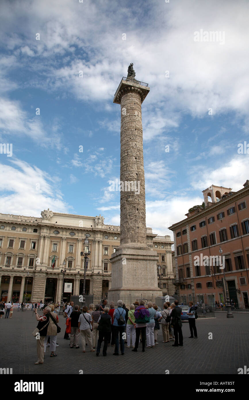 Saint Paul Column Rome group of tourists beneath the Column of Marcus Aurelius topped by ...