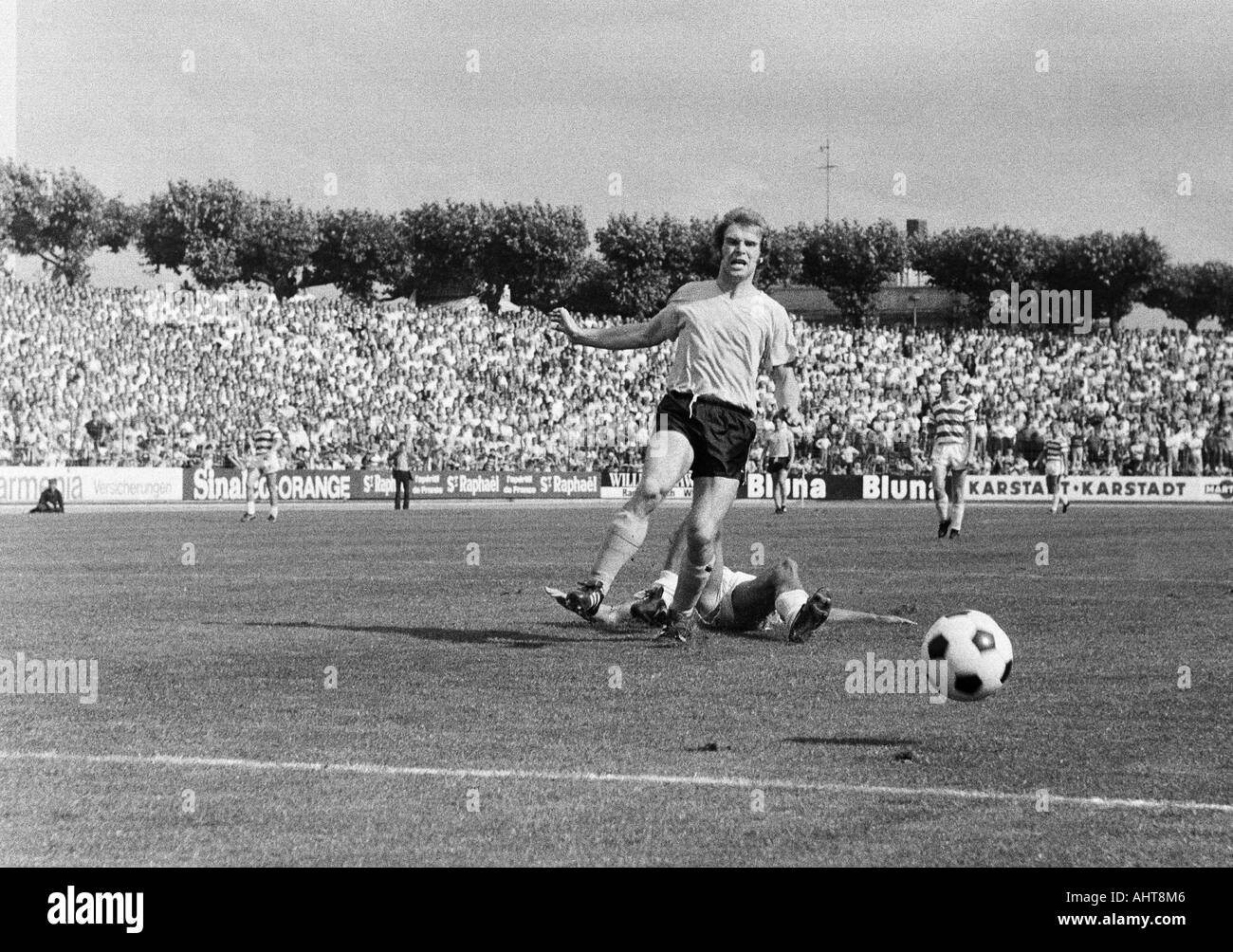 football, Bundesliga, 1971/1972, Wedau Stadium in Duisburg, MSV Duisburg versus Borussia Dortmund 2:1, scene of the match, duel between Dieter Weinkauff (BVB) and a MSV player aground Stock Photo