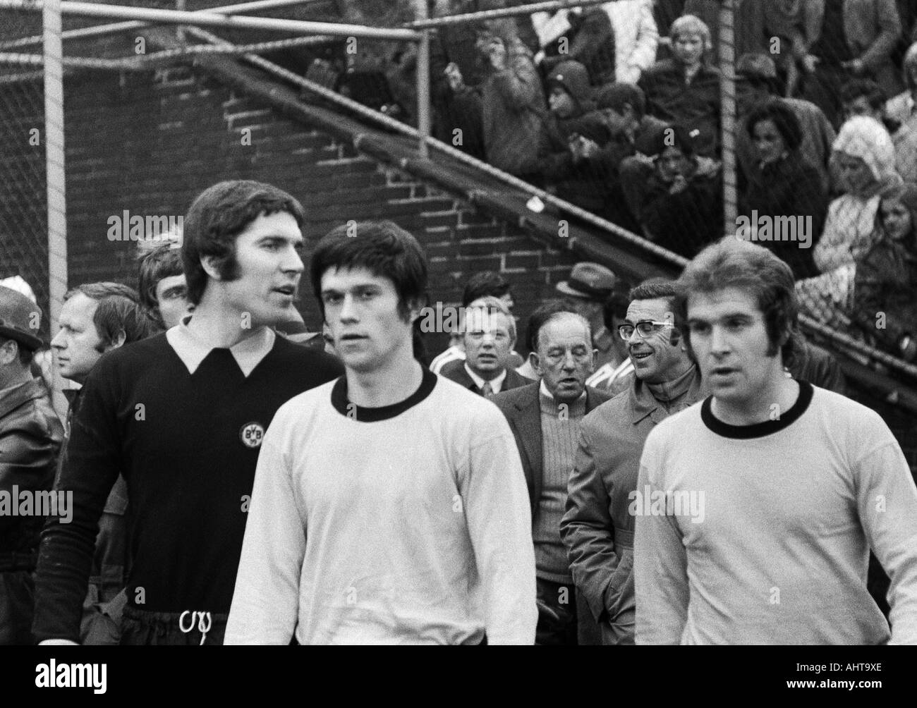 football, Bundesliga, 1971/1972, VfL Bochum versus Borussia Dortmund 4:2, Stadium at the Castroper Strasse in Bochum, football players come in the stadium, f.l.t.r. keeper Juergen Rynio (BVB), Werner Lorant (BVB), Reinhold Mathes (BVB) Stock Photo