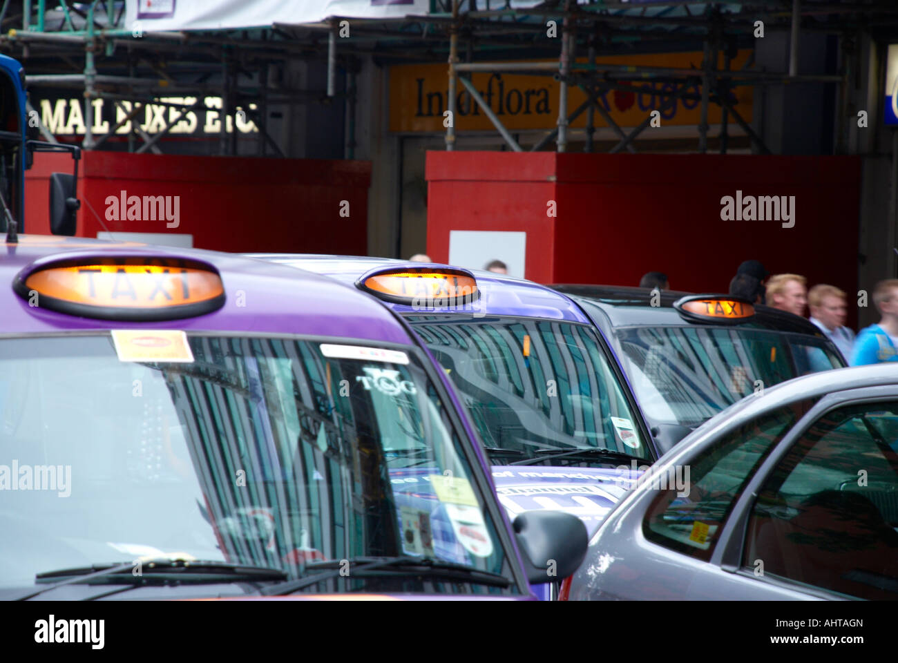 taxis on a busy manchester city centre street Stock Photo Alamy