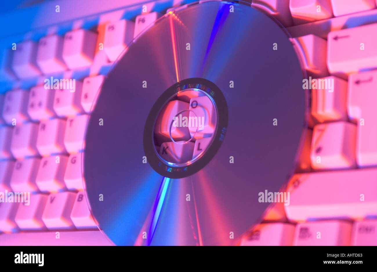 cd or dvd on a computer keyboard Stock Photo