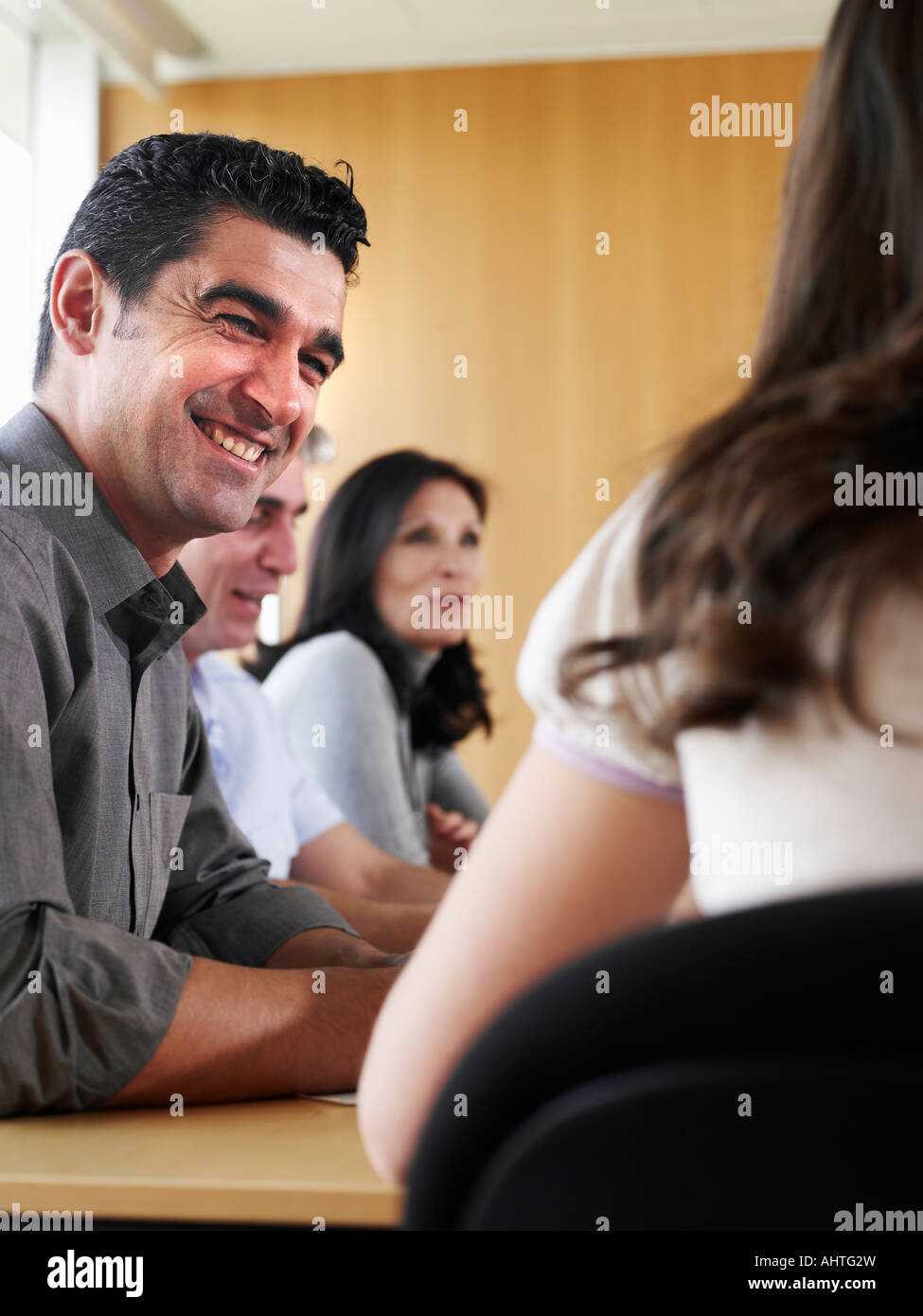 Businessman in meeting with colleagues, smiling Stock Photo