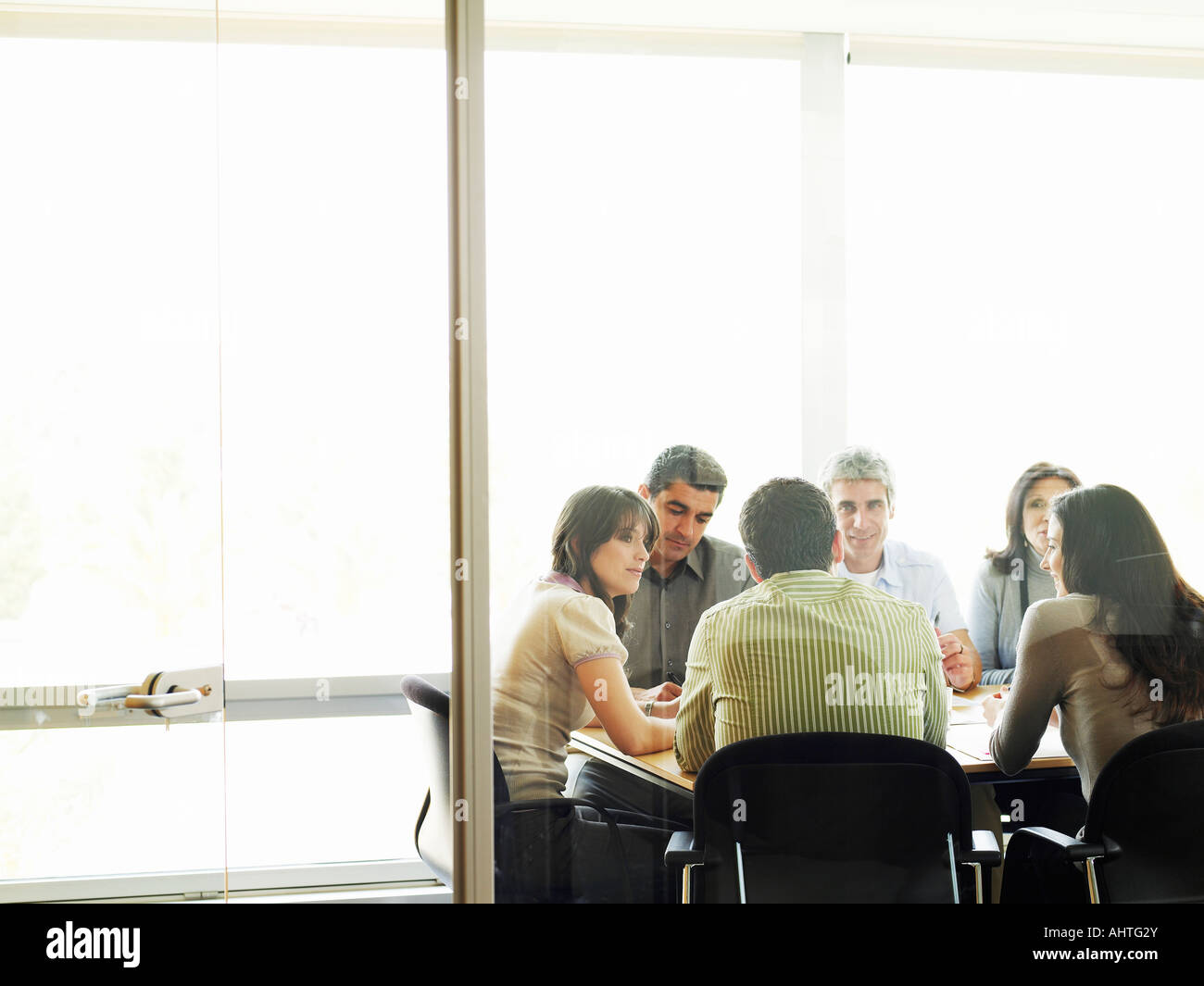 Colleagues in meeting, view through doorway Stock Photo