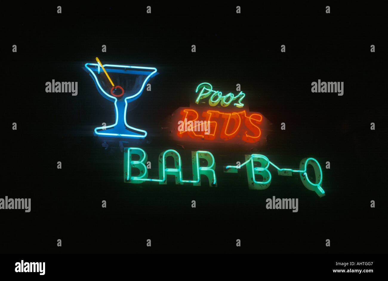 A neon sign that reads Poor Red s Bar B Q Stock Photo