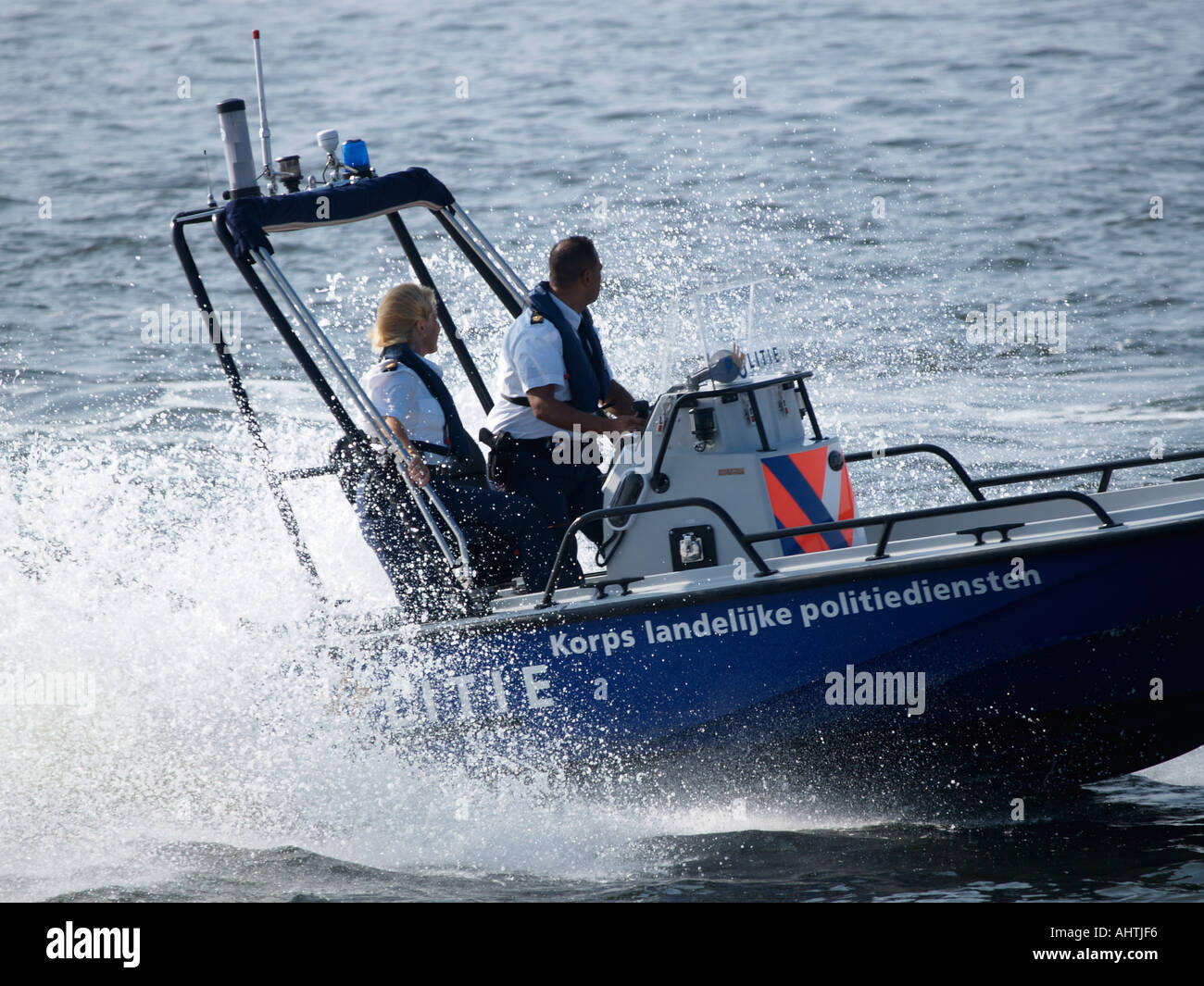 High Speed Boat Of The Dutch Water Police With 2 Officers On Board One Male One Female Amsterdam