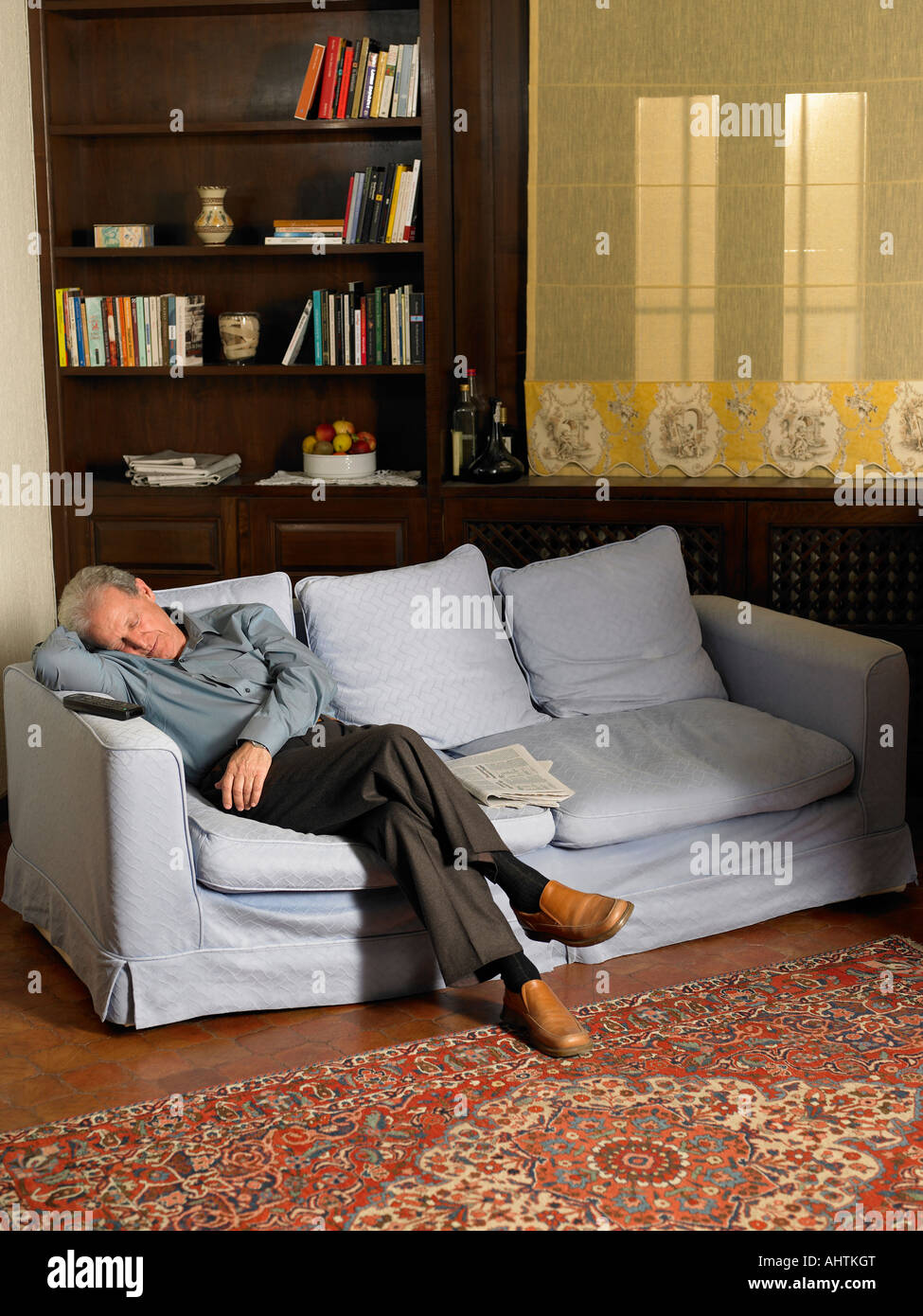Senior man asleep on sofa in living room Stock Photo - Alamy