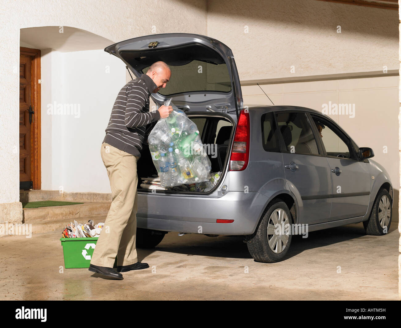 Man loading recycling into car Stock Photo