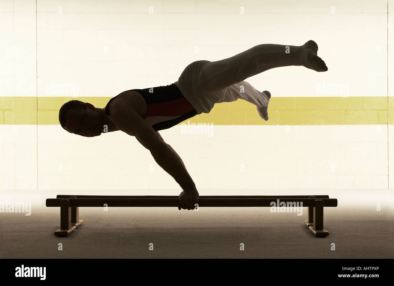 Male gymnast practising on floor bar, side view Stock Photo Alamy
