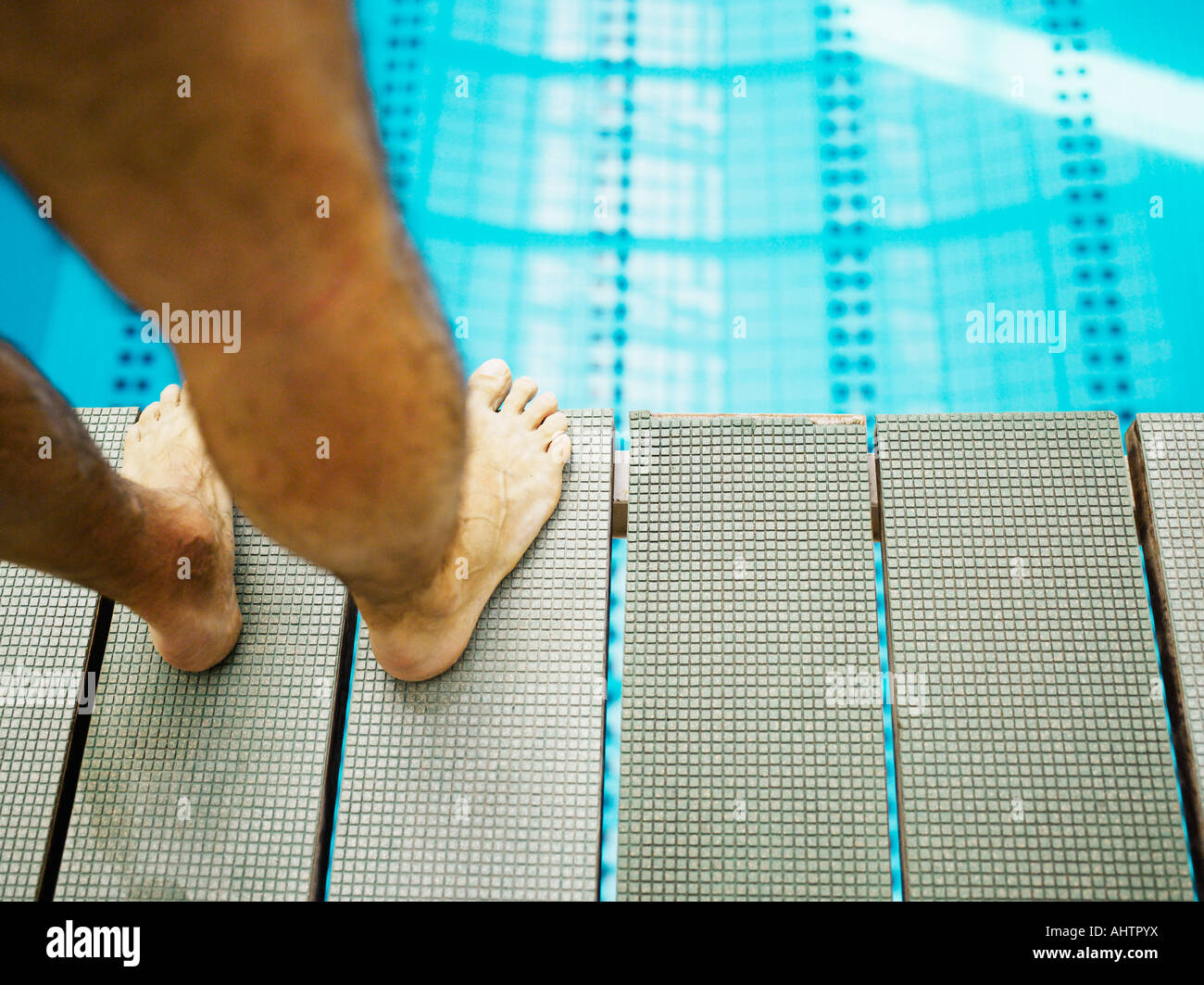 Man standing on diving board, close-up, low section Stock Photo