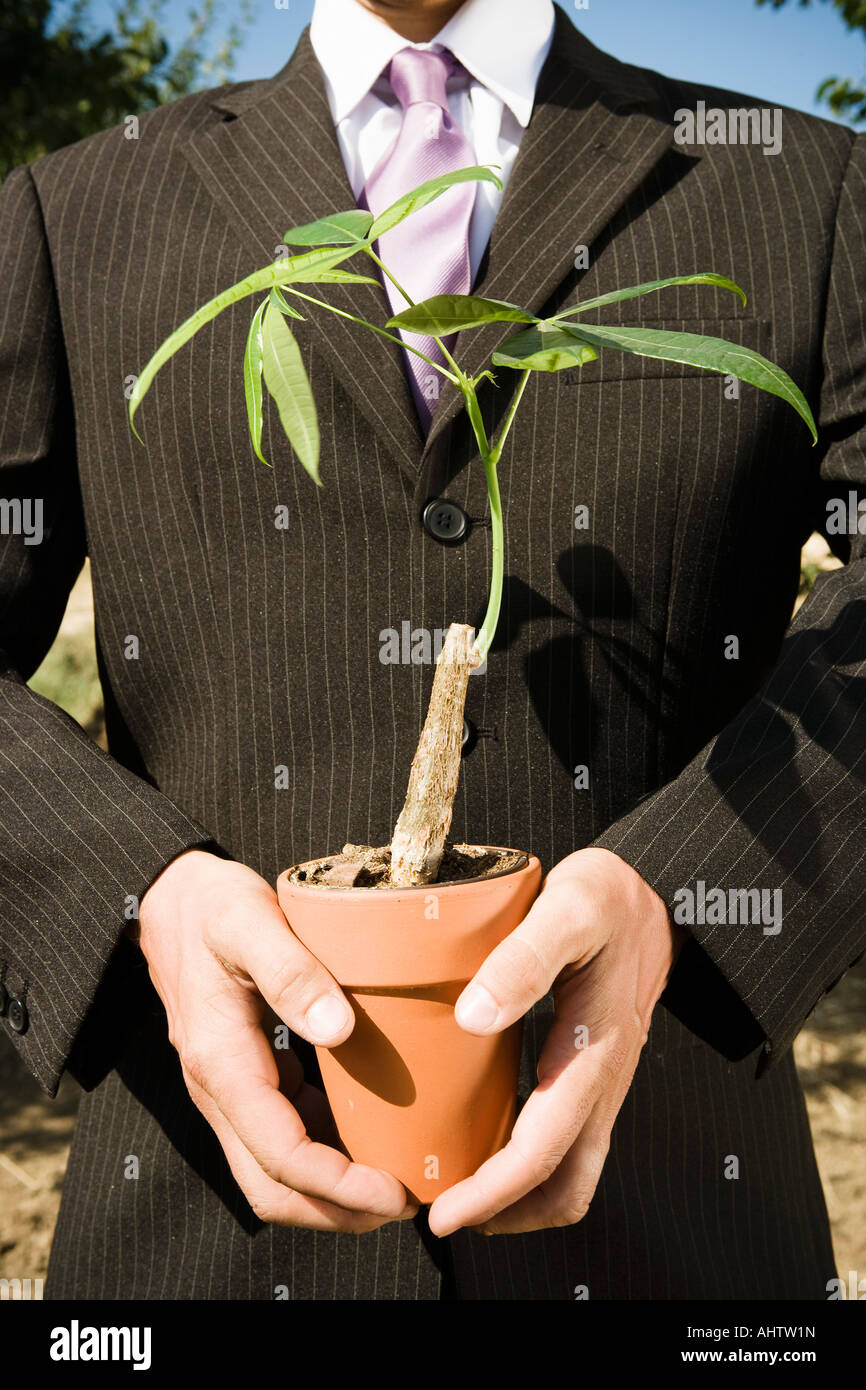Pair of hands holding potted plant Stock Photo - Alamy