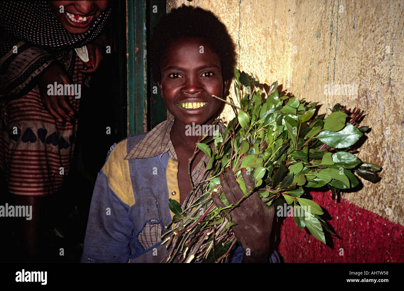 Boy working at night in a khat (kat or qat) packing shed. Ethiopia Stock Photo