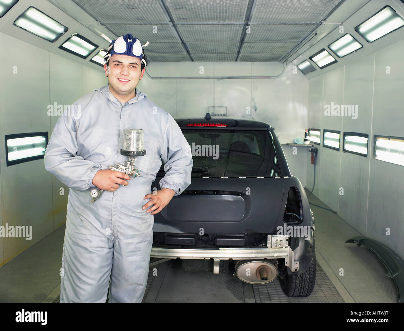 Worker ready to paint a car. Stock Photo