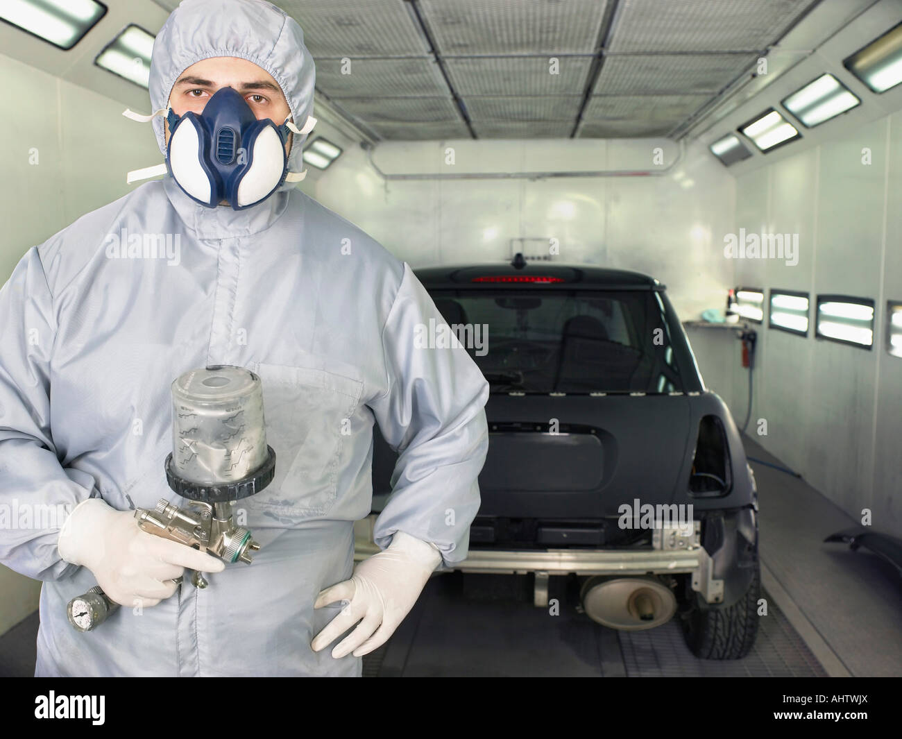 Worker ready to paint a car close up. Stock Photo