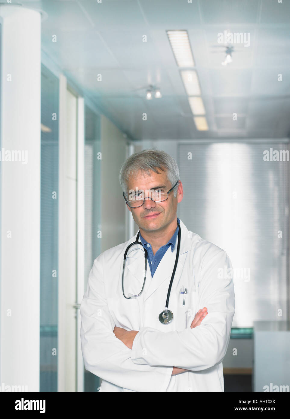 Portrait of mature male doctor in a lobby of a hospital Stock Photo - Alamy